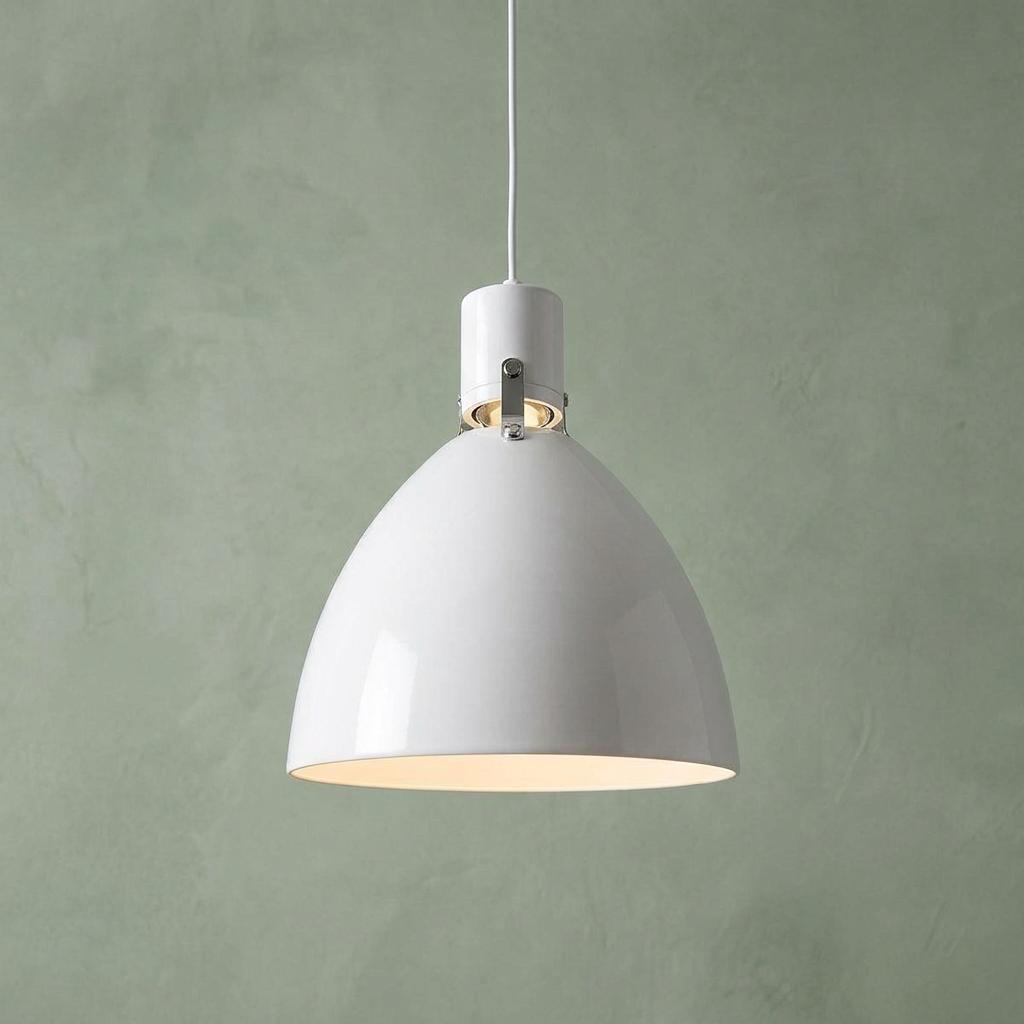 Glossy white dome pendant light with polished nickel hardware against a textured sage green wall.