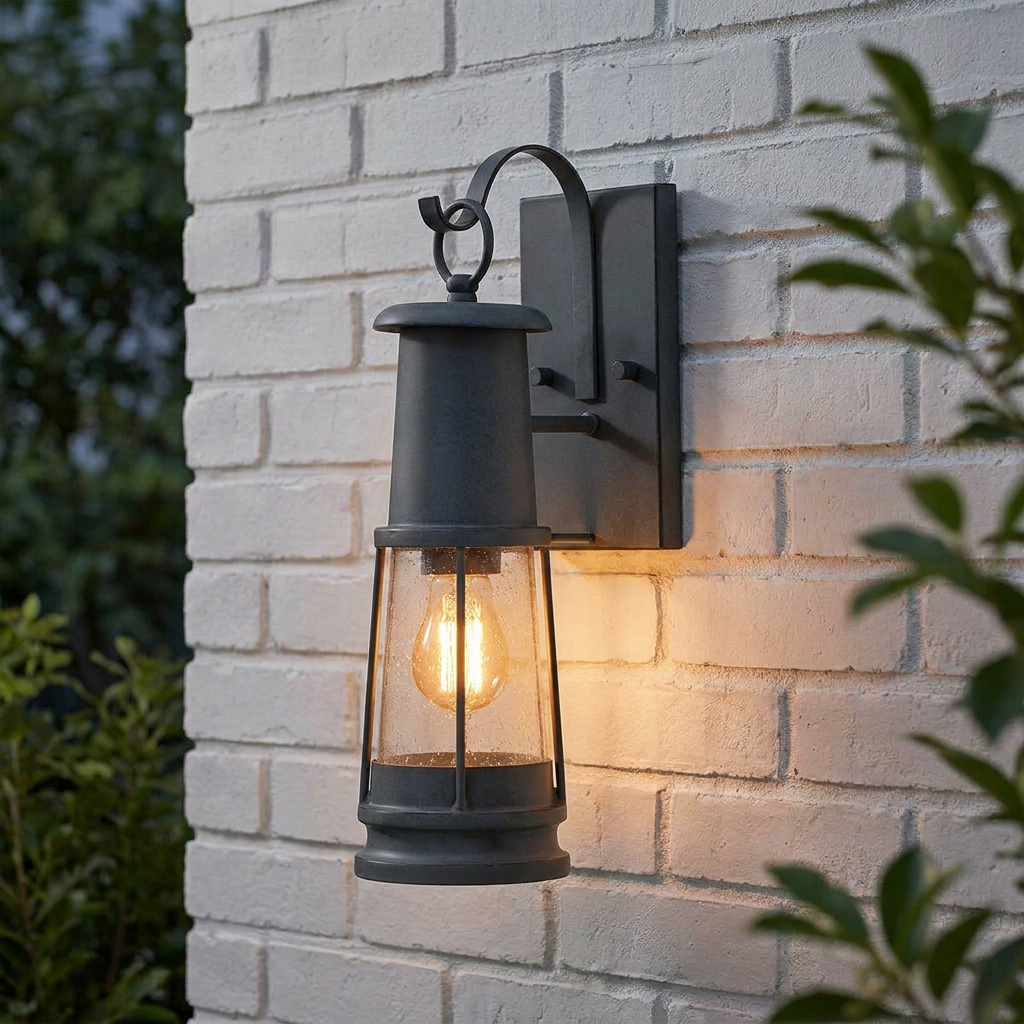 Black lantern-style outdoor wall light with seeded glass and a glowing bulb mounted on a white brick wall.