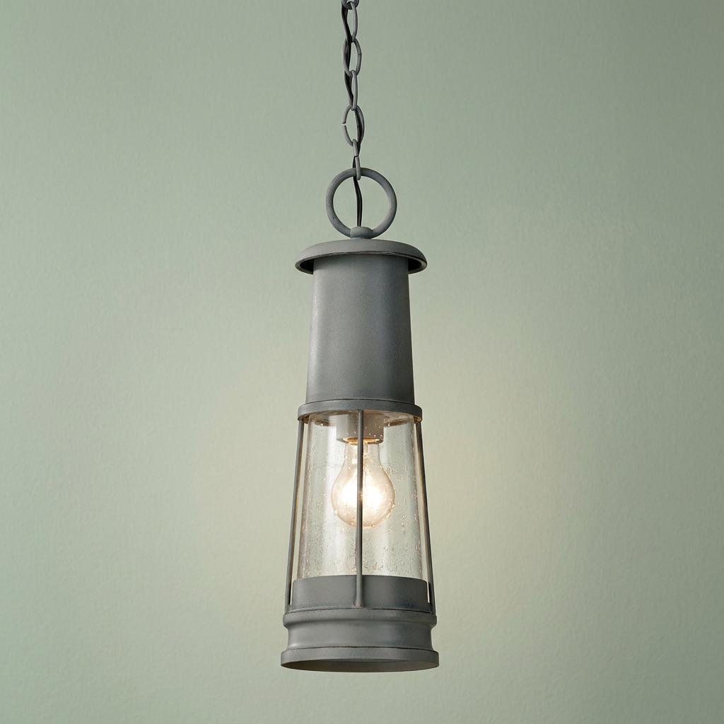 Storm cloud grey lighthouse-style outdoor pendant light with a seeded glass shade and glowing bulb.