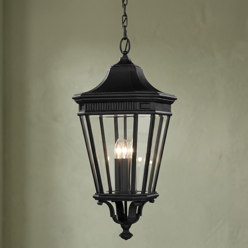Traditional black outdoor lantern pendant with clear glass panels and three candle bulbs.