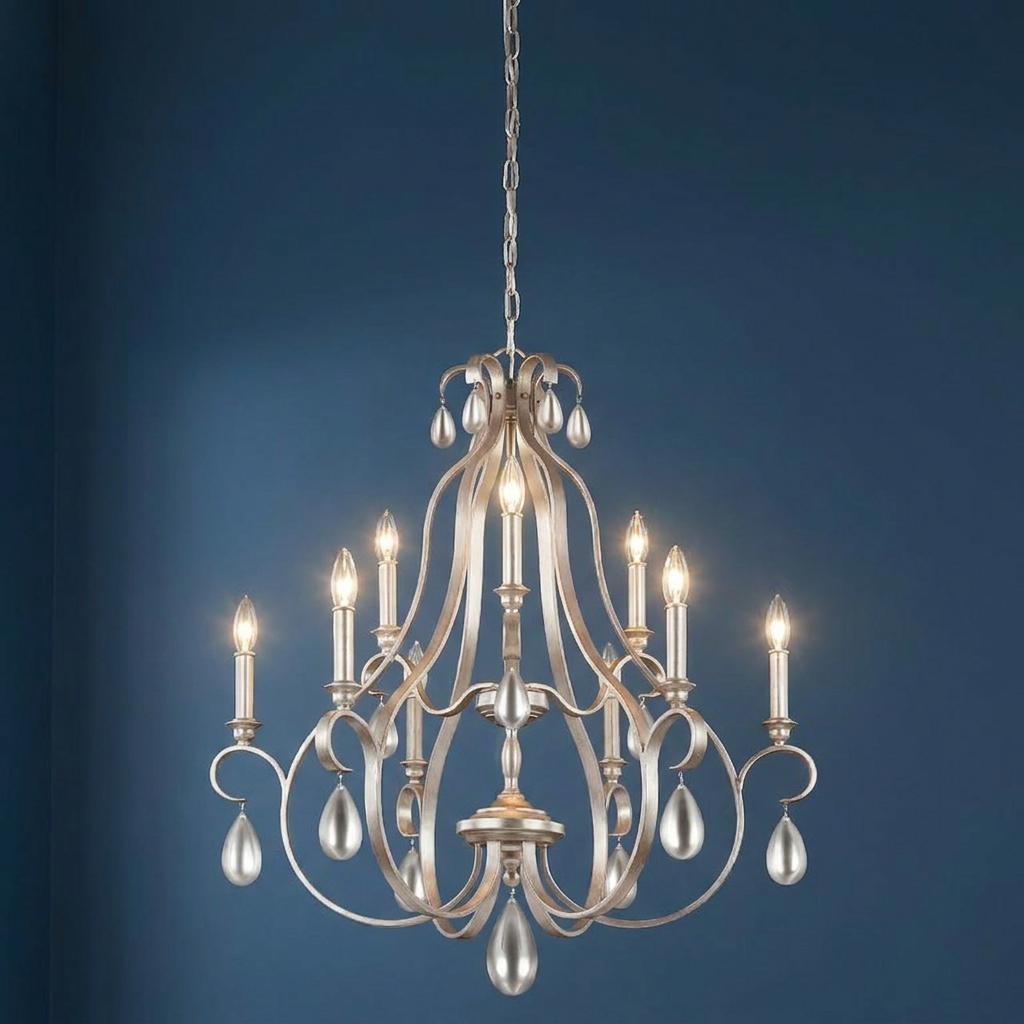 Feiss DeWitt 9 light chandelier in sunrise silver with curved arms and teardrop accents against a blue wall.