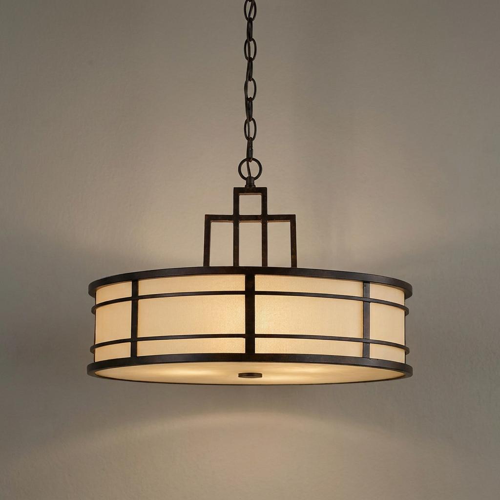 Grecian bronze pendant ceiling light with a geometric frame and glowing cream fabric shade.