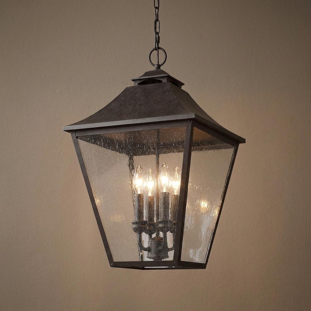 Feiss Galena 4-light outdoor chain lantern with a dark finish and seeded glass panes housing candle bulbs.