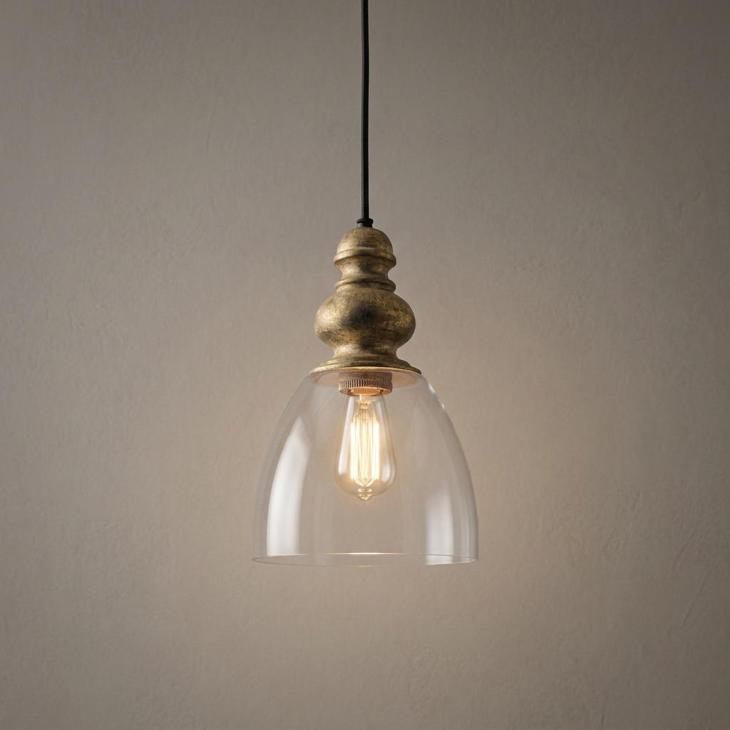 Elegant pendant light with a driftwood gold finial and clear glass bell shade, showcasing a warm vintage bulb.
