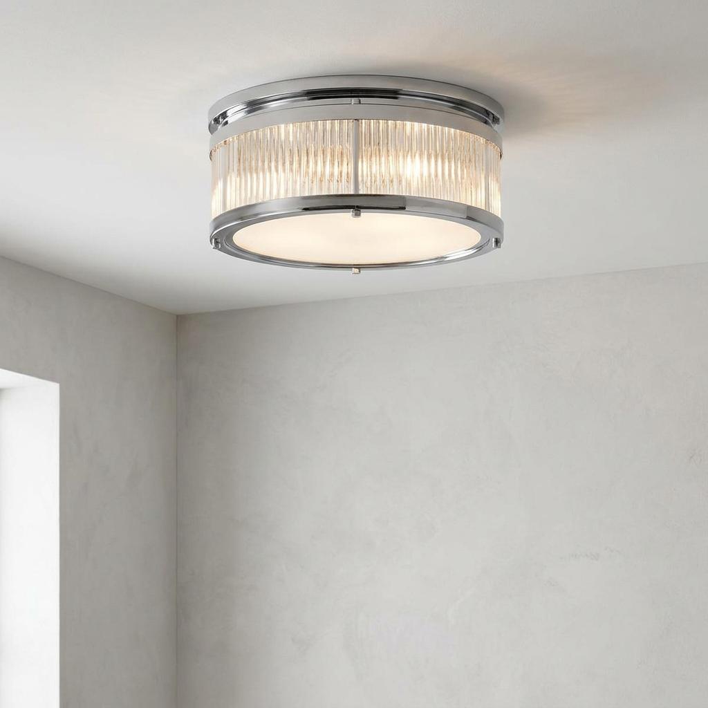 Modern chrome drum ceiling light with fluted glass sides and a frosted diffuser mounted on a plain ceiling.