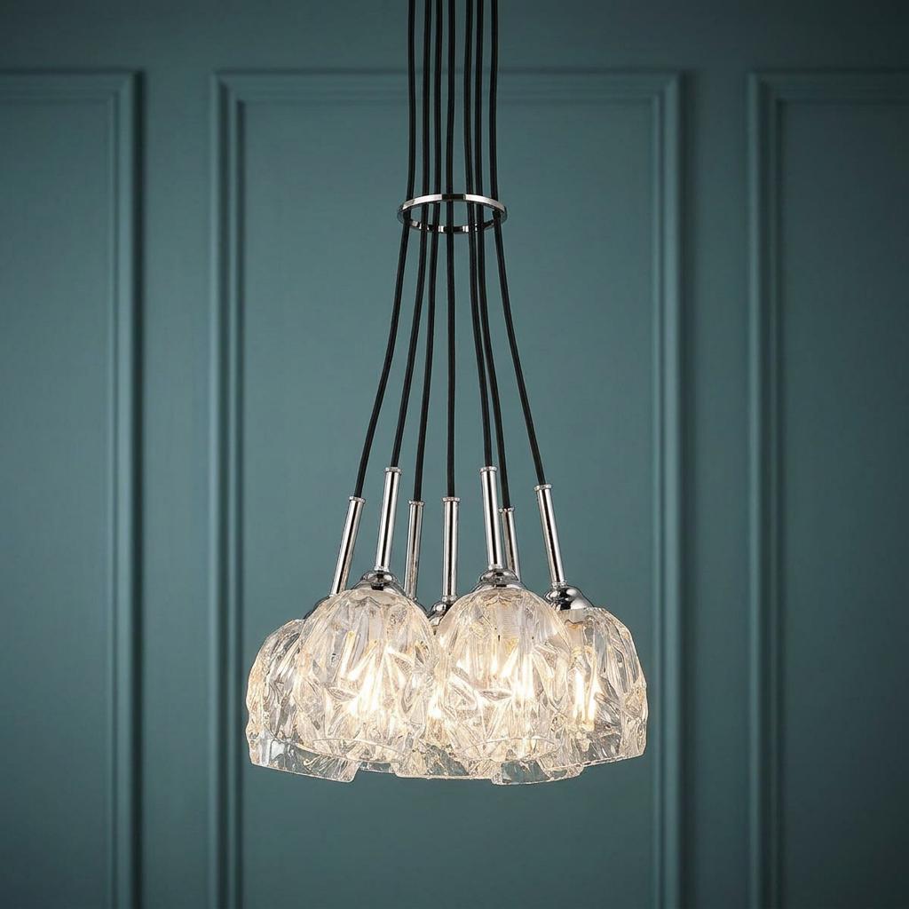 Feiss Rubin 7-light chandelier with textured glass shades and polished nickel accents against a teal paneled wall.