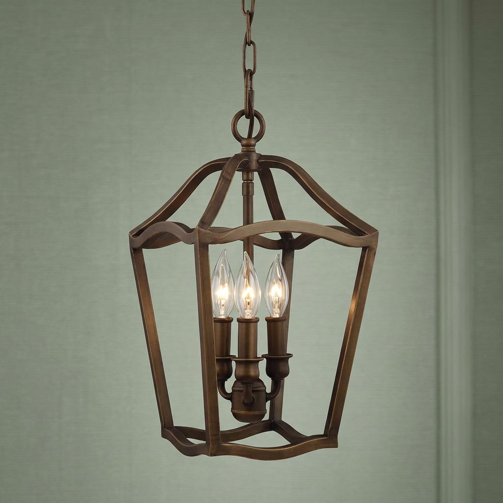 Feiss Yarmouth 3-light pendant in painted aged brass with an open-frame lantern design and candelabra bulbs.