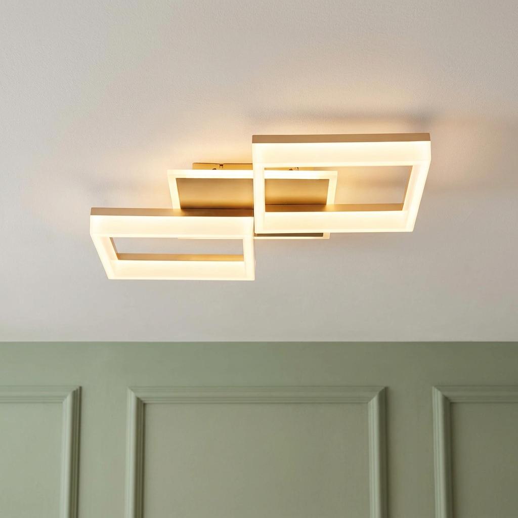 Fence gold flush ceiling light with integrated LED in two interlocking glowing rectangular frames.