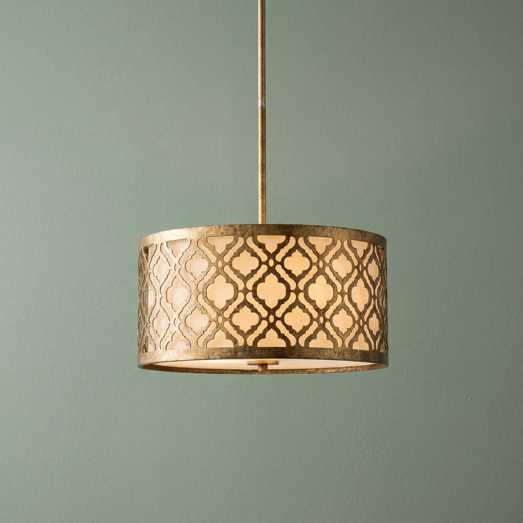 Gilded Arabella pendant light with a gold trellis pattern and white diffuser shade against a sage green wall.