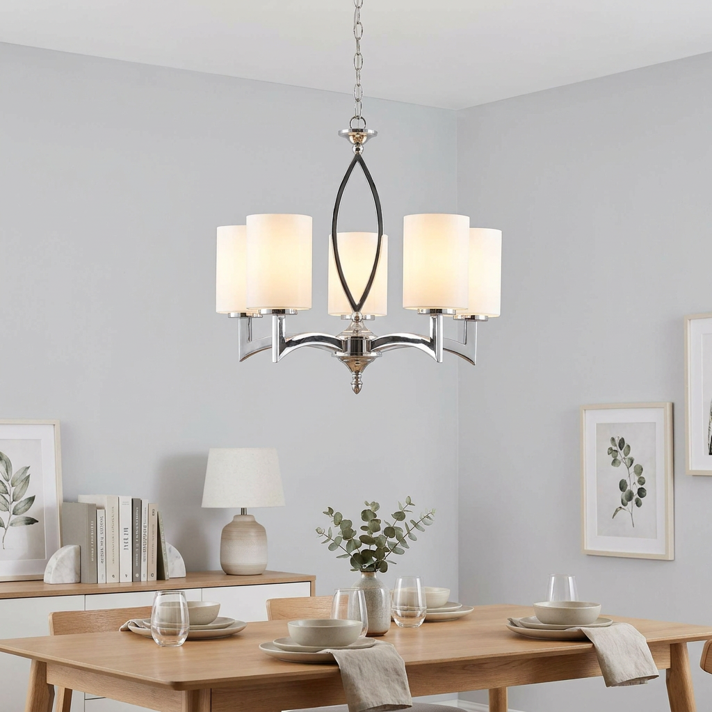 Five-light chrome ceiling pendant with cylindrical white glass shades hanging above a modern dining room table.