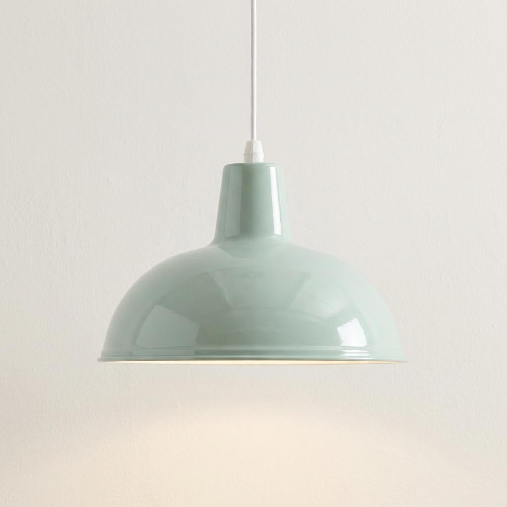 Glossy duck egg blue dome pendant ceiling light hanging from a white cord against a plain white wall.