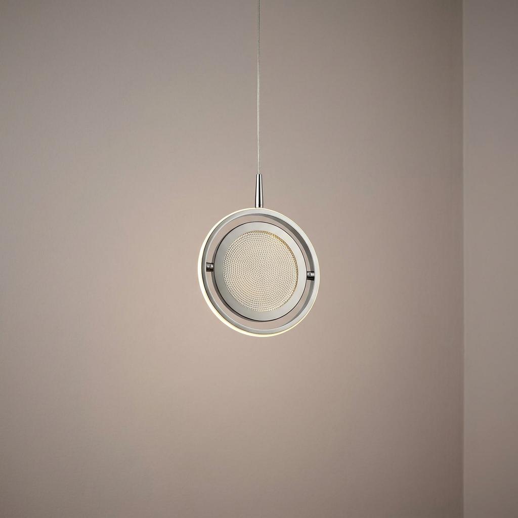 Glowing chrome and crystal gyroscope-style LED ring pendant light suspended against a plain wall.