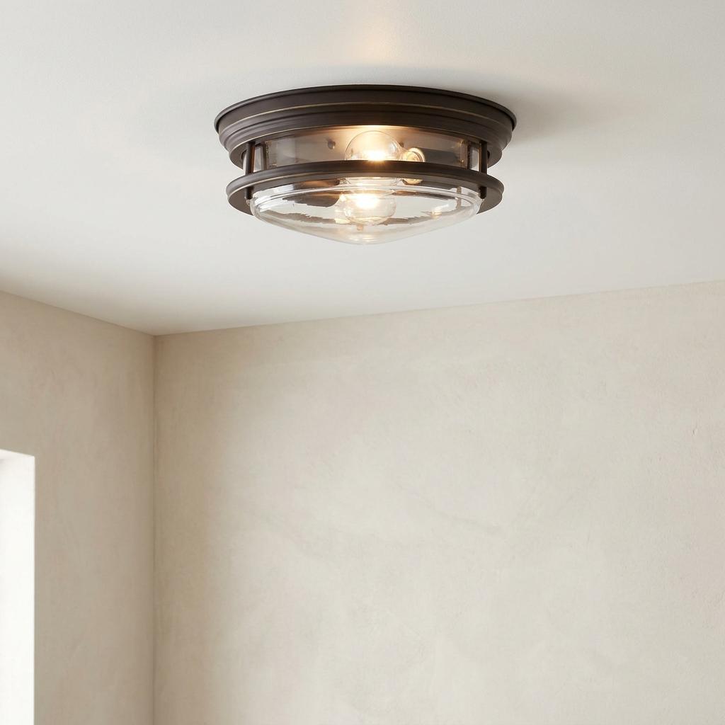 Hadrian 2-light bathroom flush ceiling fixture with oil-rubbed bronze finish and clear glass shade.