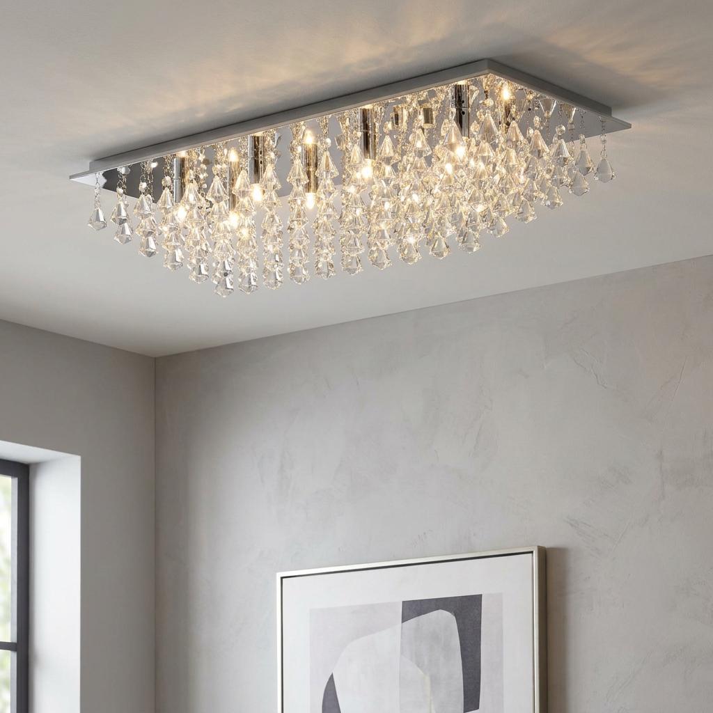 Rectangular chrome ceiling flush light with cascading crystal pyramid drops illuminated in a modern interior.