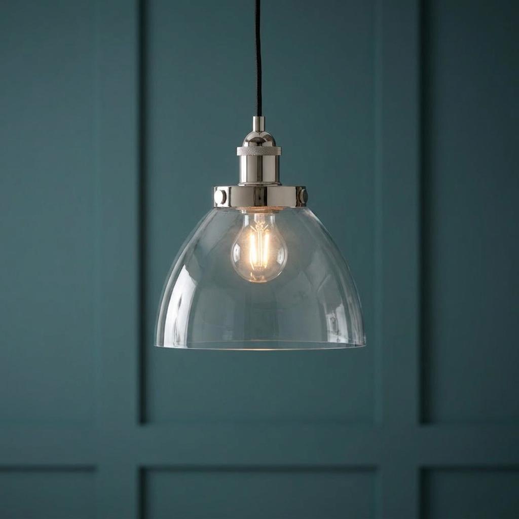 Hansen nickel industrial pendant light with a clear glass shade against a teal paneled wall.