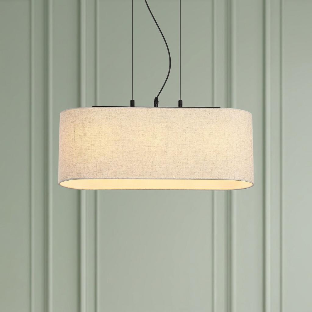 Oval oatmeal linen pendant light with black hardware hanging against a light green paneled wall.