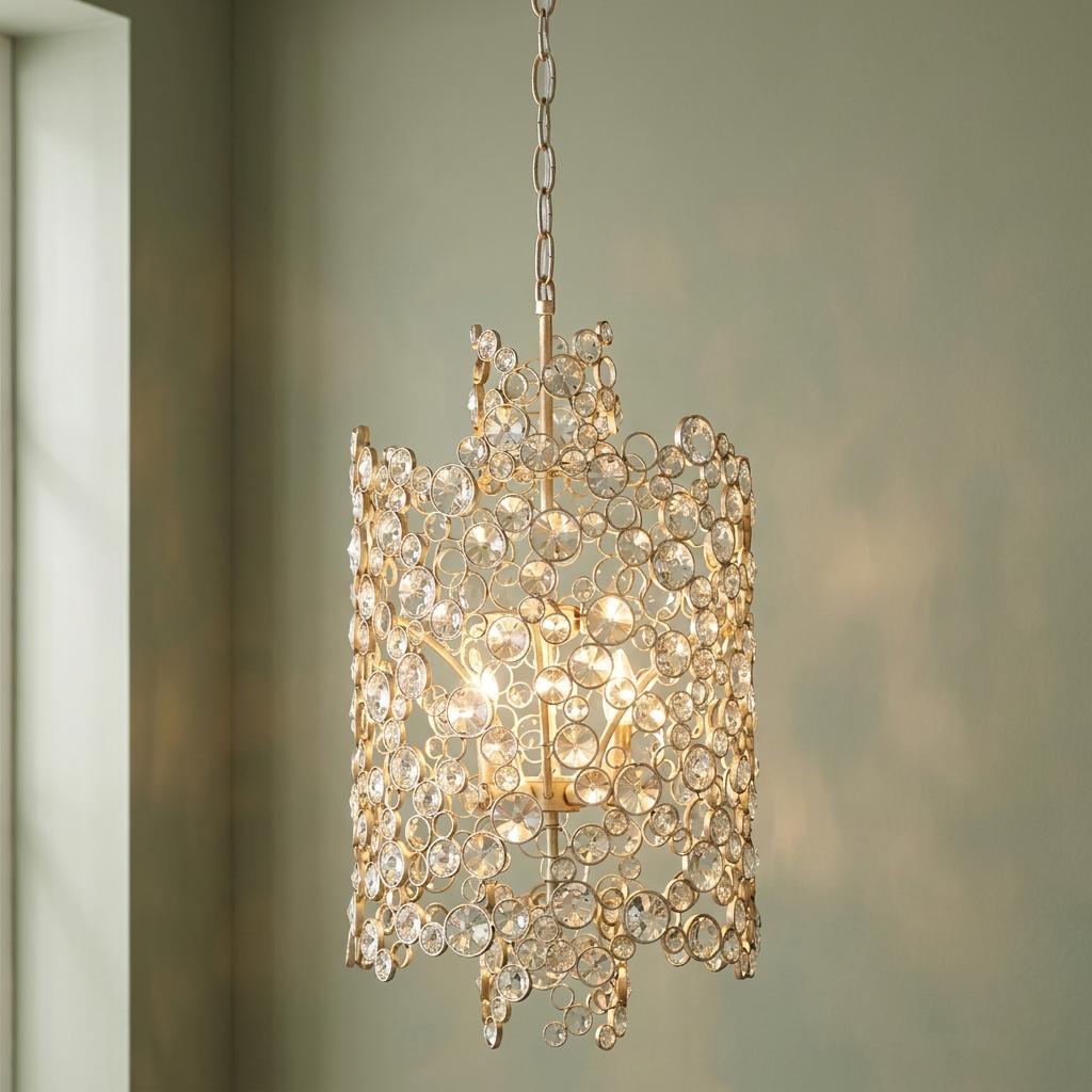 Hinkley Anya pendant light with shimmering crystal circles in a two-tier silver frame, illuminated against a green wall.