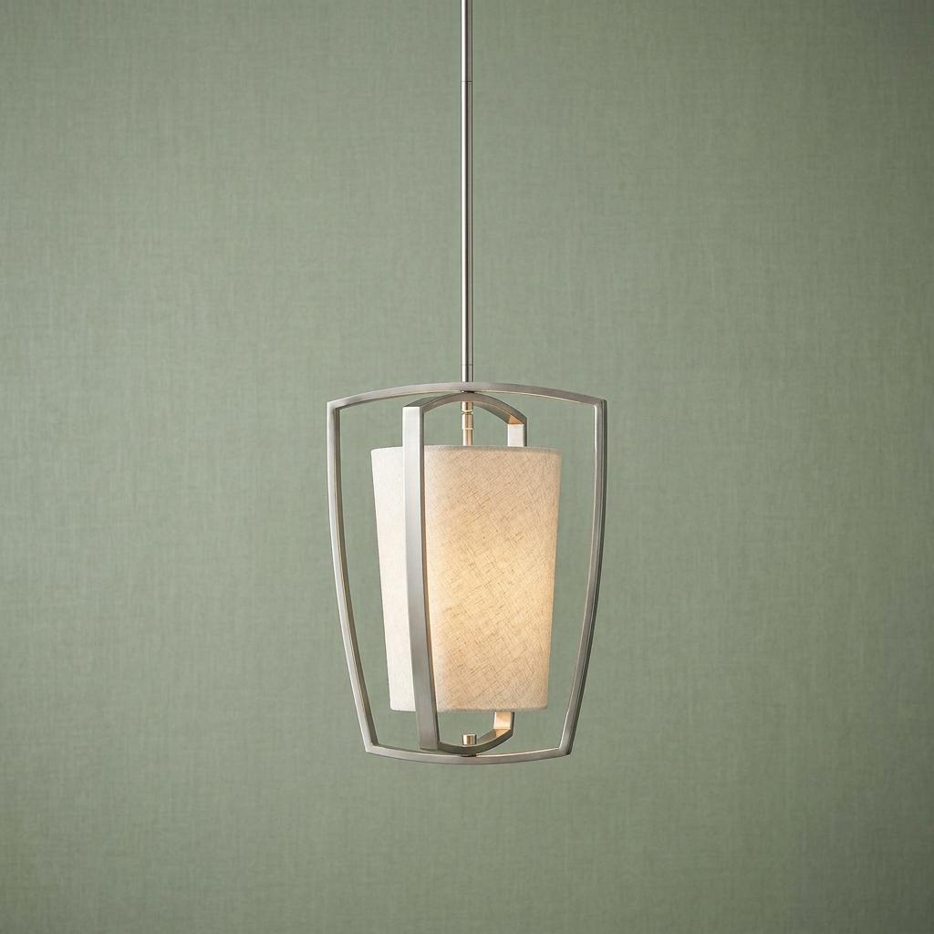 Brushed nickel pendant with a glowing fabric shade and curved open frame against a textured green wall.