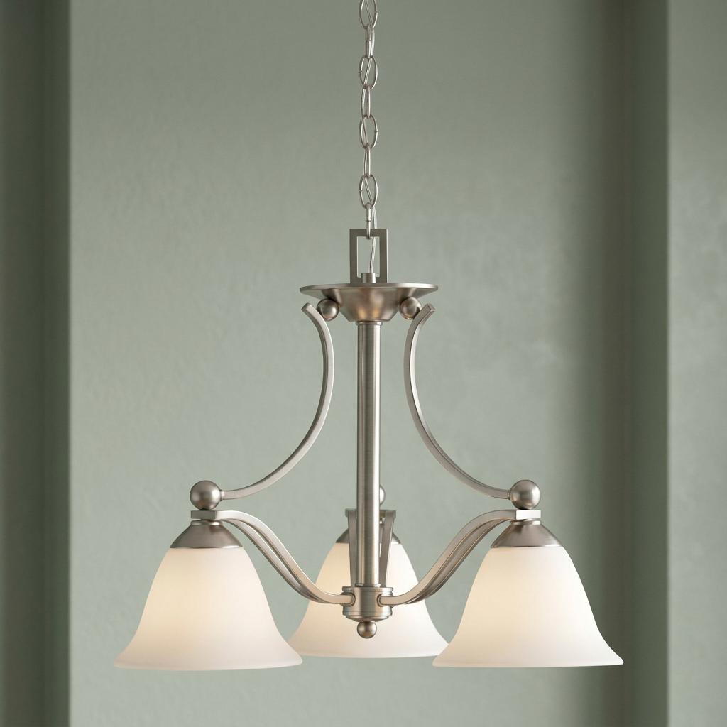 Hinkley Bolla 3-light brushed nickel chandelier with frosted glass shades hanging against a green wall.