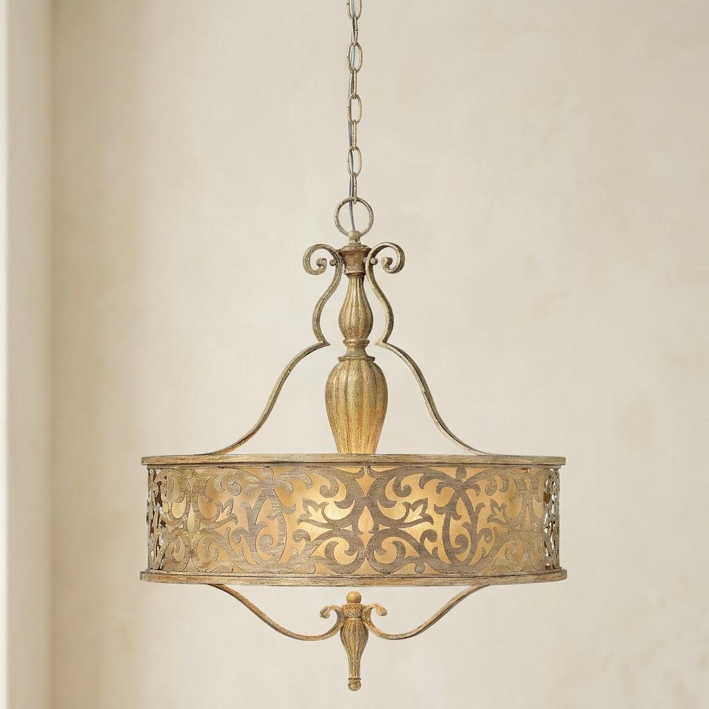 Brushed champagne pendant light featuring an intricate scrollwork metal shade and elegant finials.
