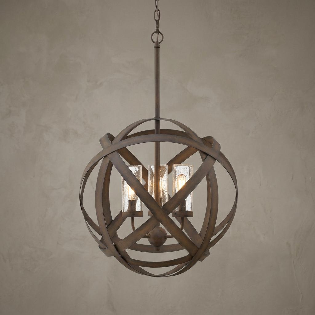 Industrial dark bronze orb outdoor pendant light with three clear seeded glass shades against a neutral wall.
