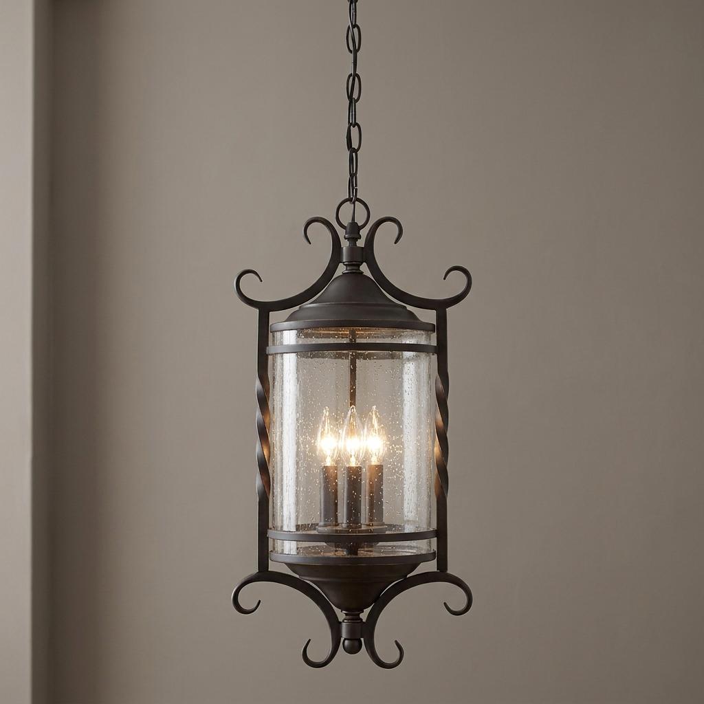 Black three-light outdoor lantern with seeded glass and ornate scrollwork hanging from a chain.