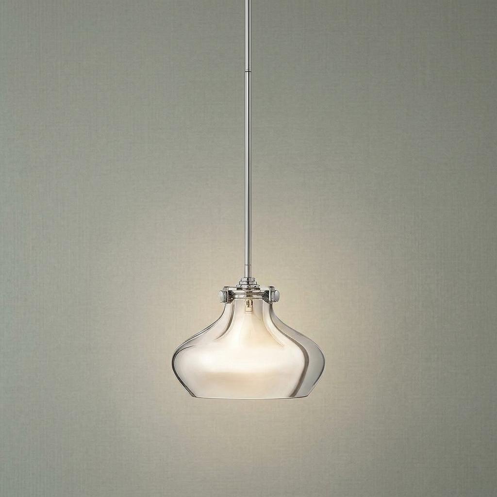 Hinkley Congress chrome pendant light with a clear curved glass shade glowing against a textured grey wall.