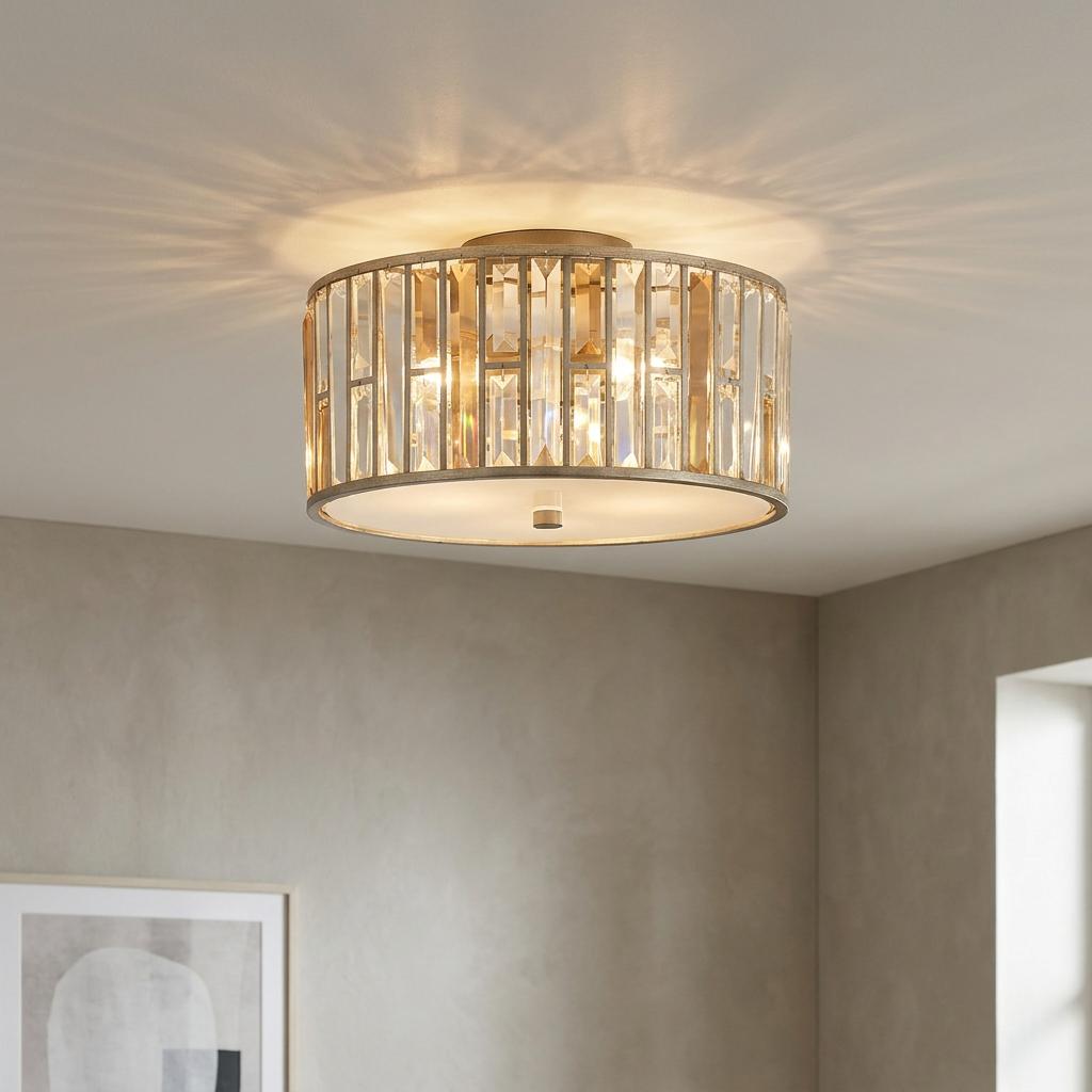 Hinkley Gemma flush ceiling light with silver leaf frame and sparkling crystal prisms, illuminated in a modern room.