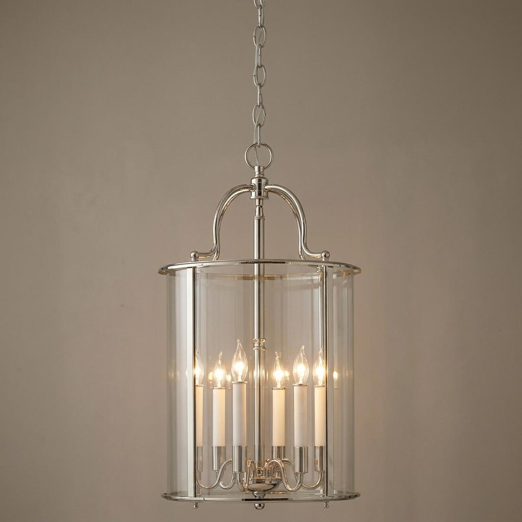 Large polished nickel lantern pendant featuring six candle-style lights and clear glass panels.