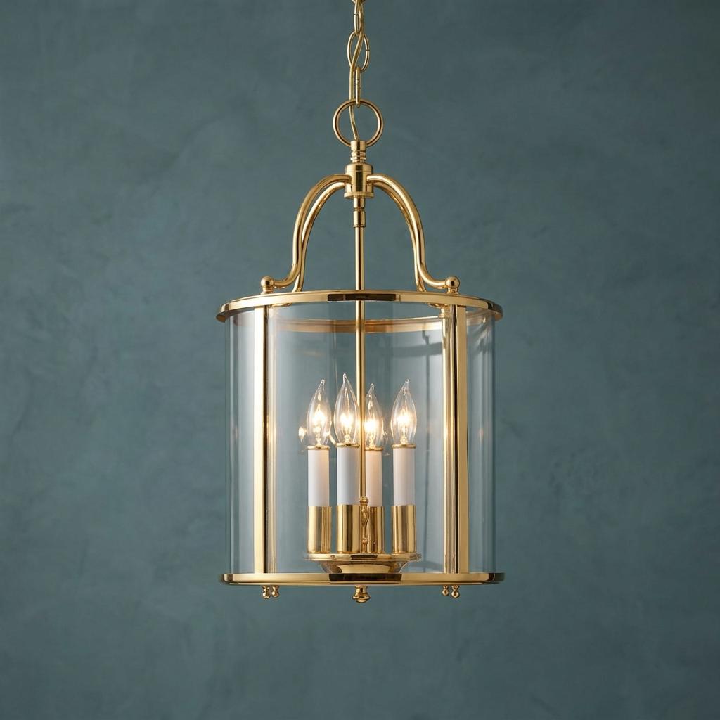 Polished brass medium ceiling lantern with clear glass panels and four candle lights against a textured blue wall.