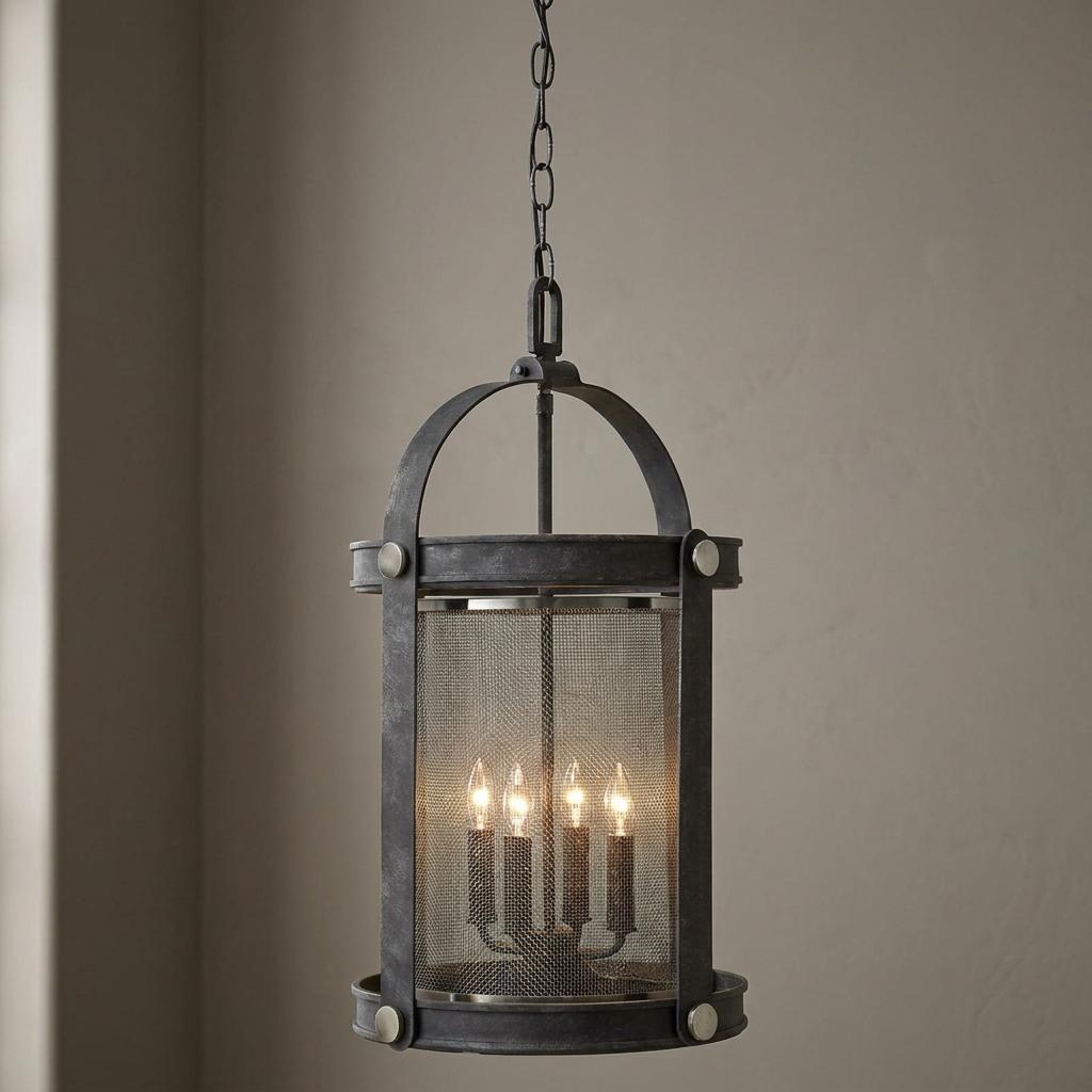 Industrial zinc lantern with a fine mesh screen and four glowing candle-style bulbs hanging from a chain.