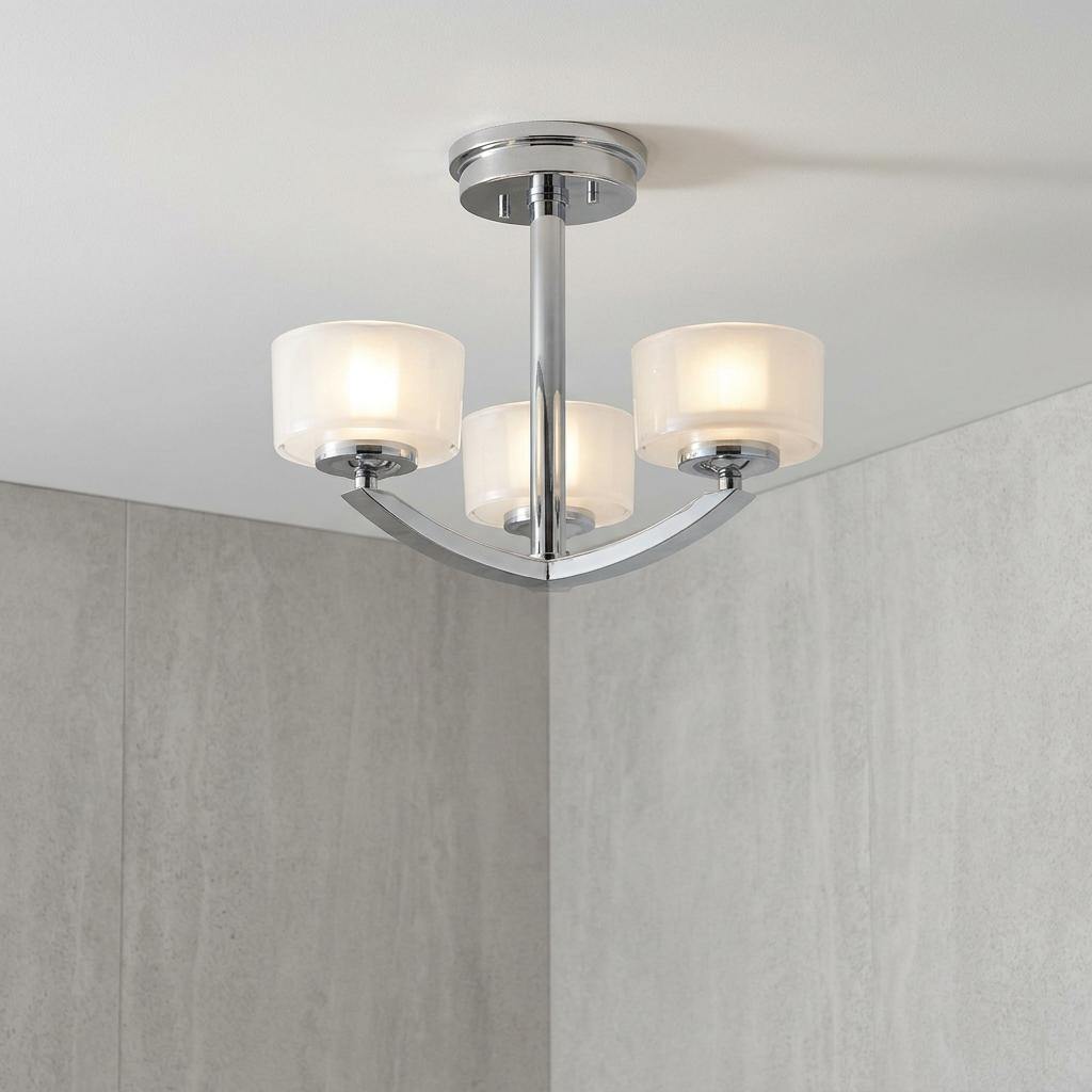 Hinkley Meridian 3-light chrome semi-flush ceiling fixture with frosted glass shades in a bathroom.