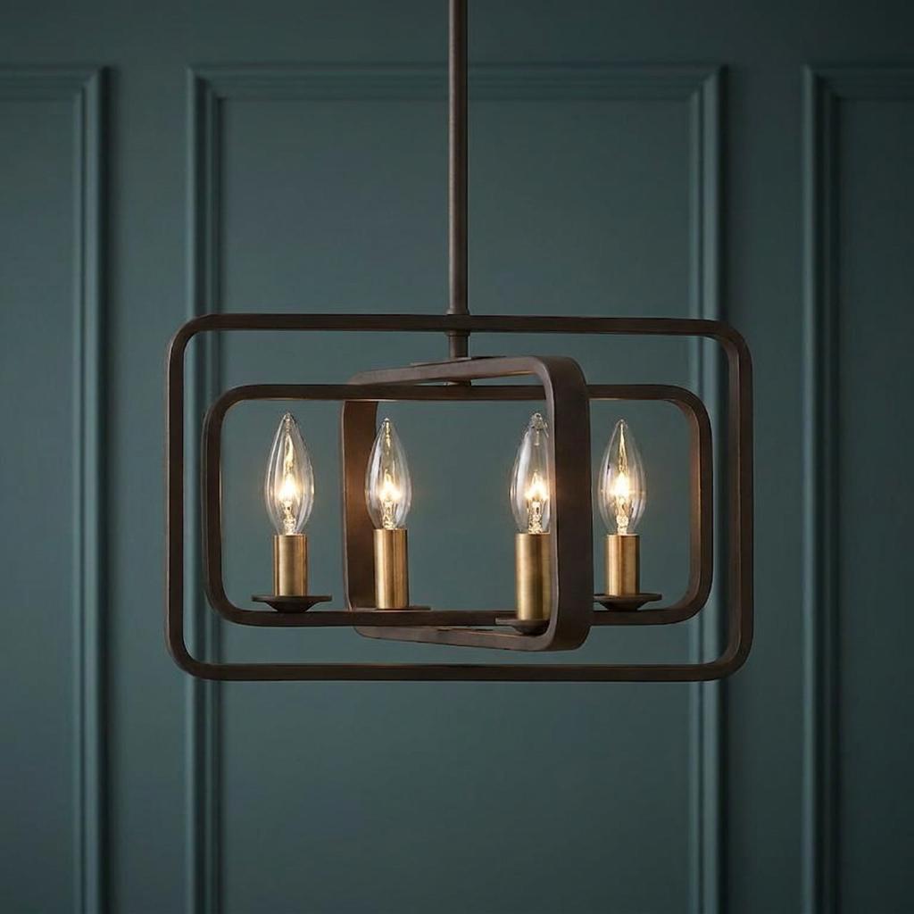 Bronze four-light pendant chandelier with nested rectangular frames and warm candle bulbs against a teal paneled wall.