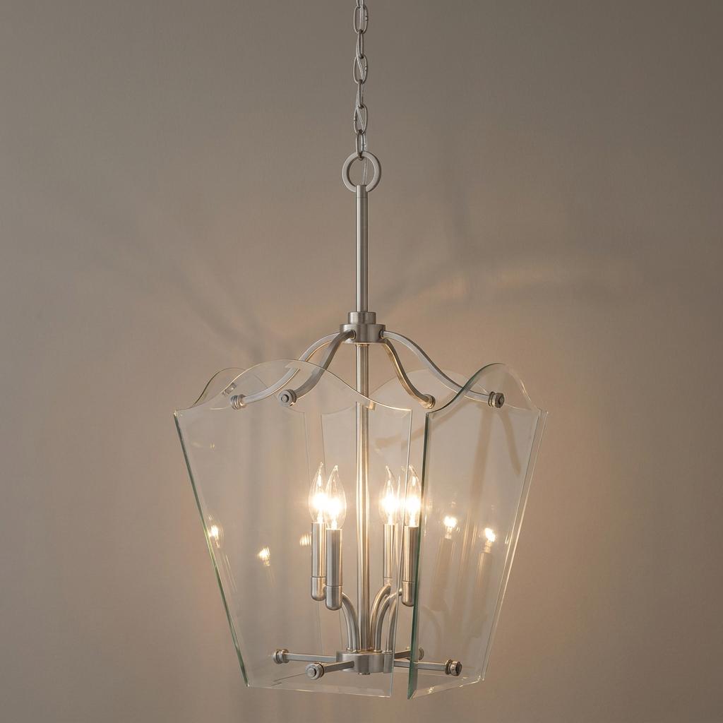 Four-light nickel lantern with scalloped clear glass panels hanging against a neutral wall.