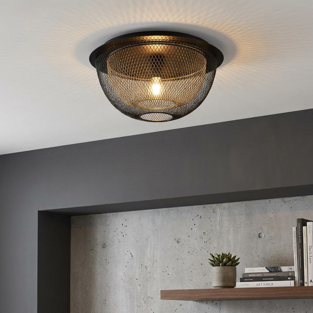 Honeycomb-patterned black and gold mesh flush mount ceiling light illuminating a modern room with grey walls.