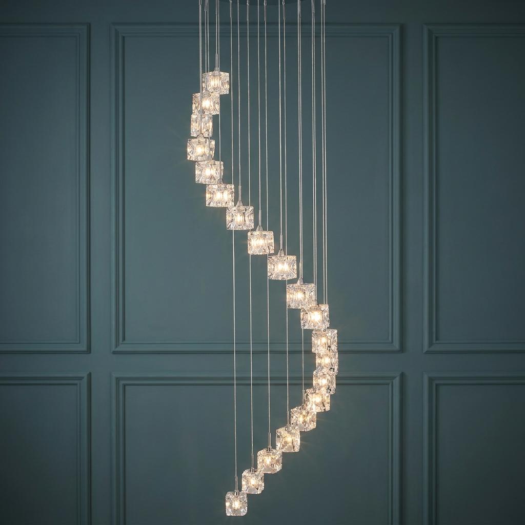 A spiral of 20 glowing glass ice cube pendant lights suspended against a dark blue paneled wall.