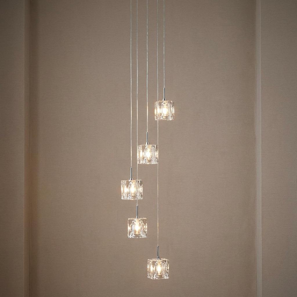 Five-light multi-drop chrome pendant with ice-cube glass shades hanging in a staggered arrangement.