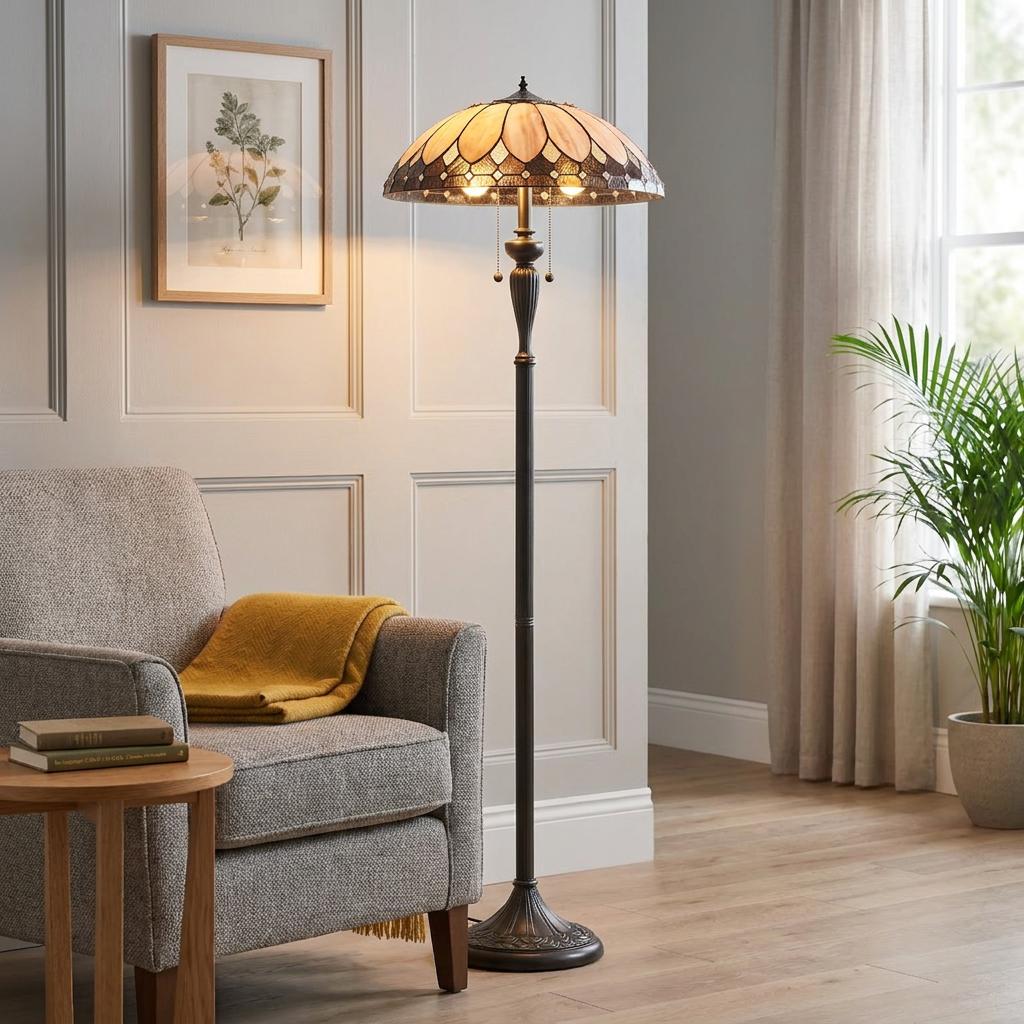 Brooklyn Tiffany floor lamp with amber stained glass shade by a grey armchair in a panelled living room.
