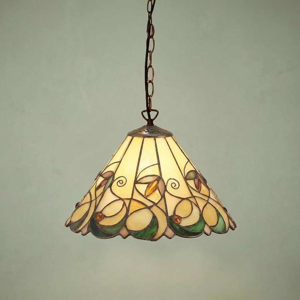 Small Tiffany pendant light with an intricate floral stained glass shade in amber and green hanging from a chain.