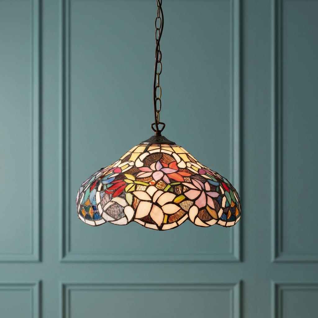 Sullivan small Tiffany ceiling light with a floral stained glass shade hanging against a teal paneled wall.