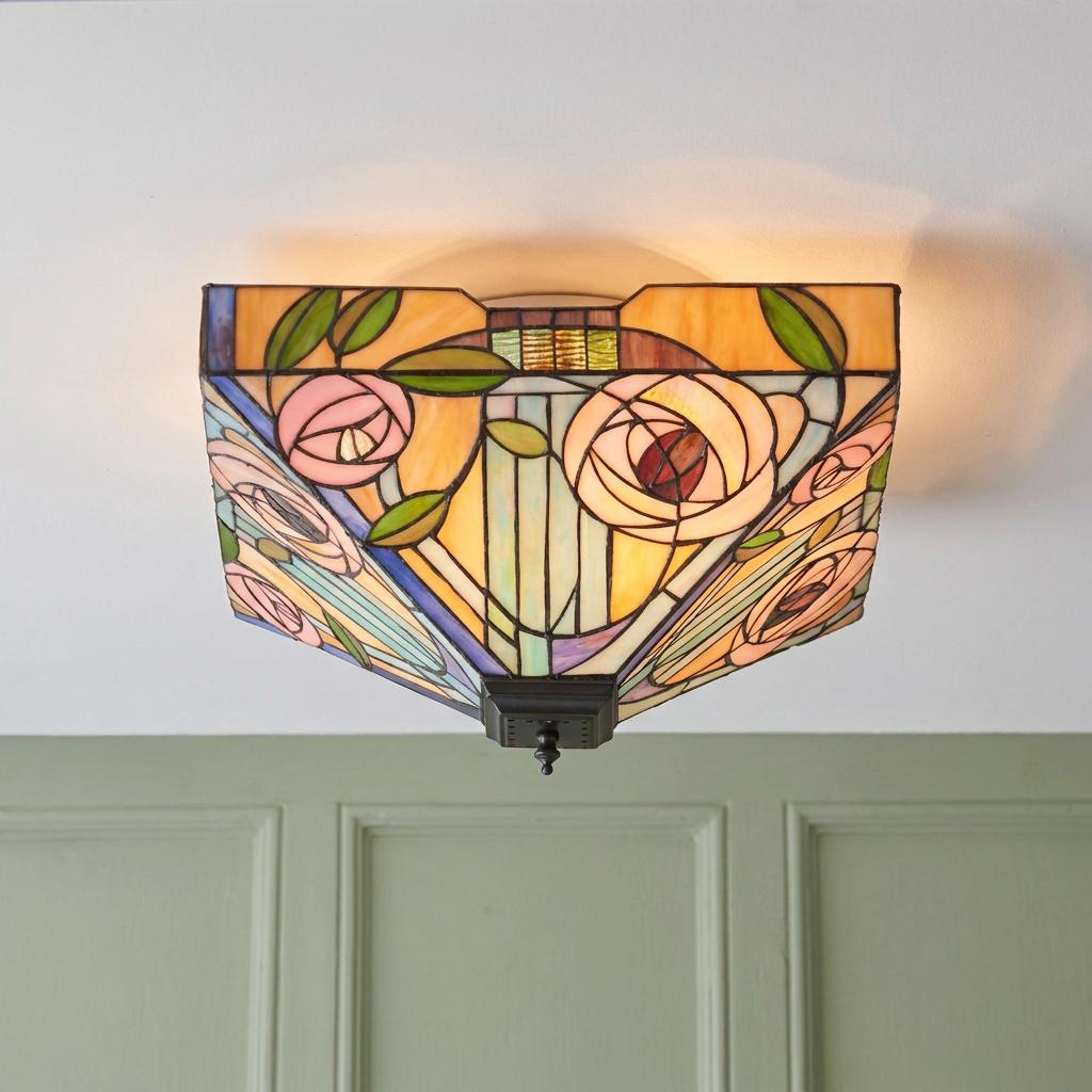 Large Tiffany flush ceiling light with a pink rose stained glass design mounted on a white ceiling.