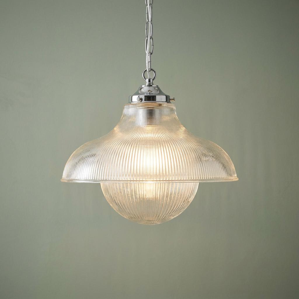 Kansa Duo Prismatic Ceiling Light with a ribbed glass shade and chrome chain against a soft green wall.