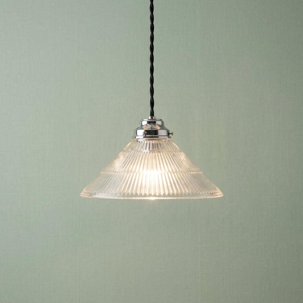 A conical prismatic glass pendant light with a chrome fitting and black twisted cord against a pale green wall.
