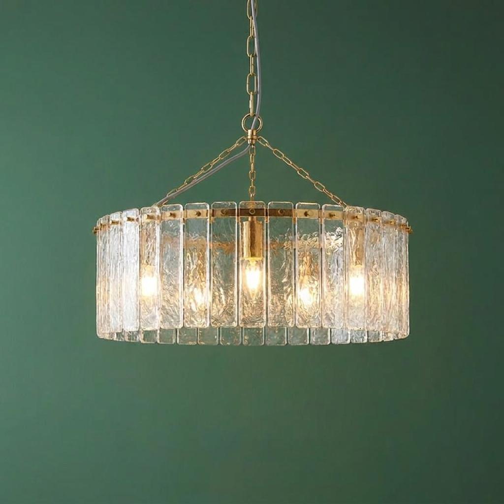 Karine 5-light brass pendant with textured handmade glass panels against a dark green background.
