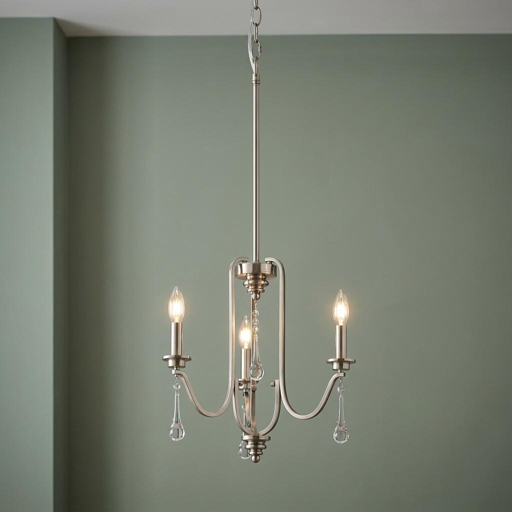 Karlee 3-light pewter chandelier with candle-style bulbs and crystal droplets against a sage green wall.