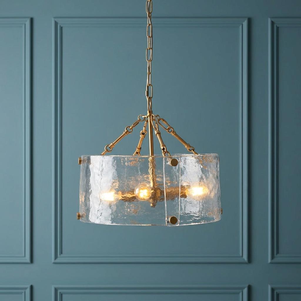 A Keller 4-light brass pendant with curved textured glass panels hanging against a blue paneled wall.