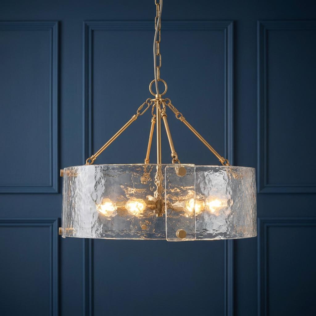 Keller 6 Light Brass Pendant with textured curved glass panels against a dark blue paneled wall.