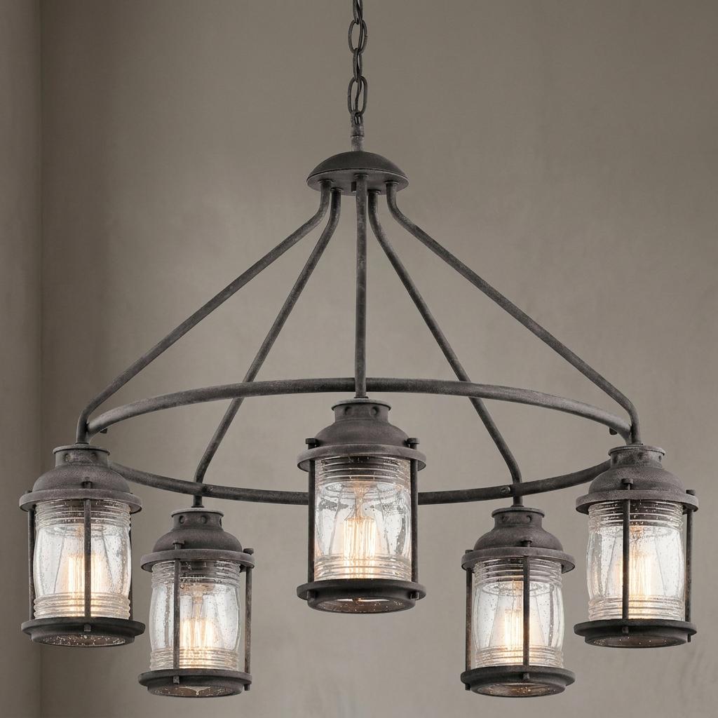 Weathered zinc 5-light outdoor chandelier with clear seeded glass lanterns on a circular metal frame.