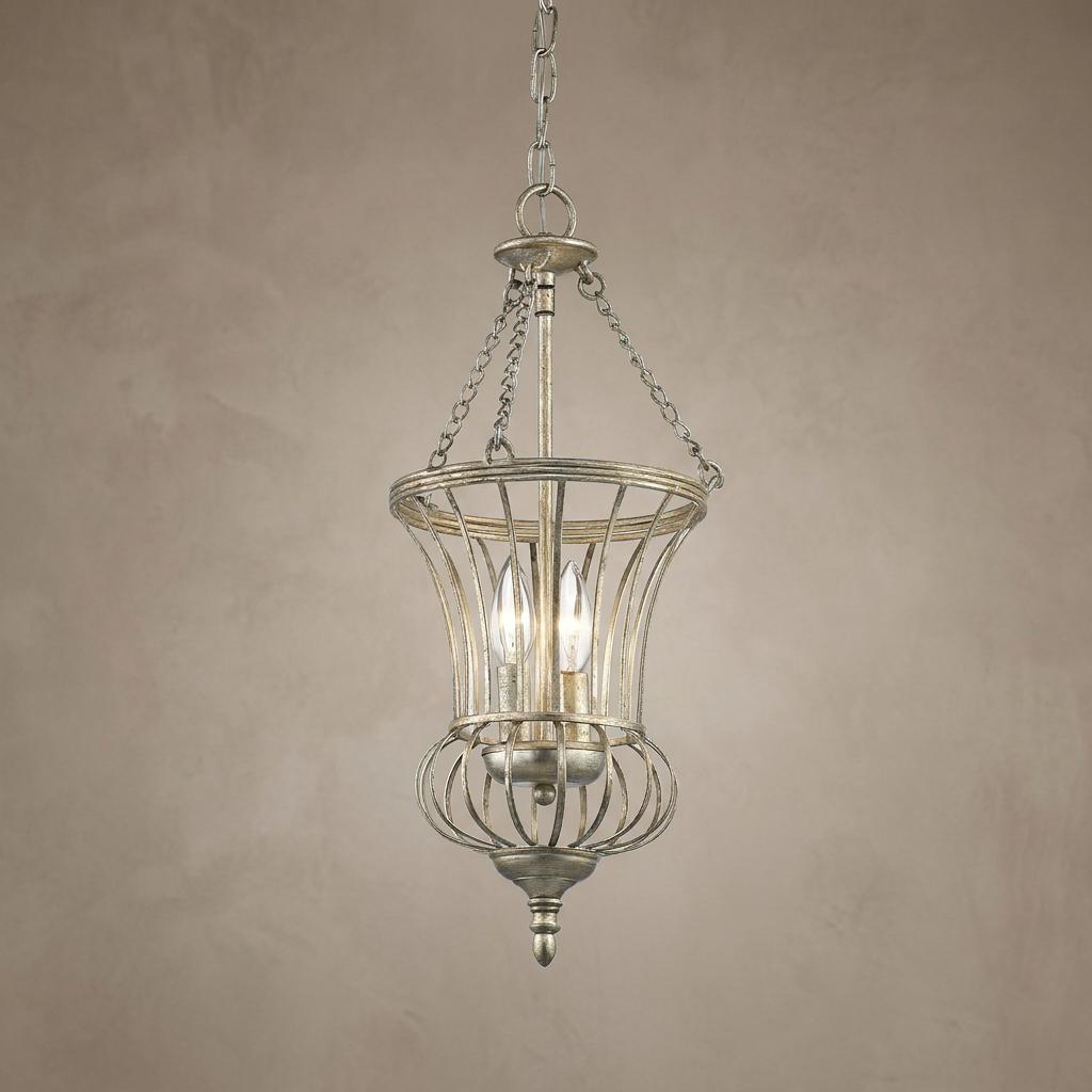 Small gold pendant ceiling light featuring a curved metal wire cage and two glowing candelabra bulbs.