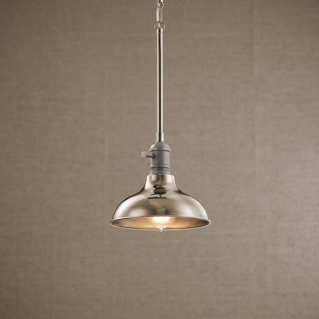 Single industrial mini pendant with a polished nickel dome shade against a textured beige wall.